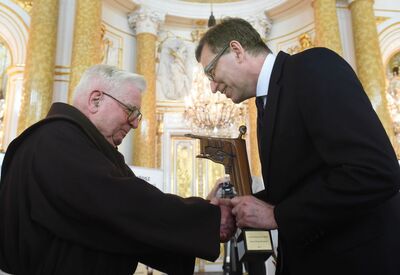Prezes IPN wręcza statuetkę Kustosza Pamięci Narodowej o. Antoniemu Herkulanowi Wróblowi z zakonu bernardynów (Fot. Radek Pietruszka/PAP)